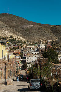 High angle view of townscape against clear blue sky