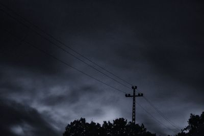 Low angle view of silhouette trees against sky