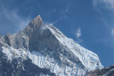 Low angle view of mountain against cloudy sky