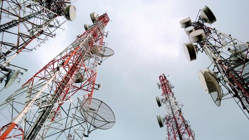 Low angle view of communications tower against sky