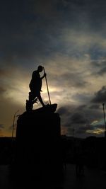 Low angle view of silhouette statue against sky during sunset