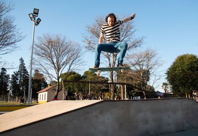 Skateboarder trick jumping in the air 