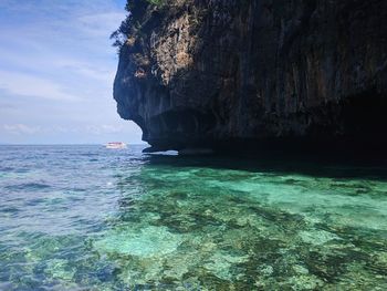 Rock formation in sea against sky