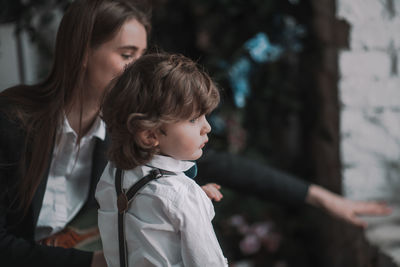 High angle view of siblings looking up outdoors