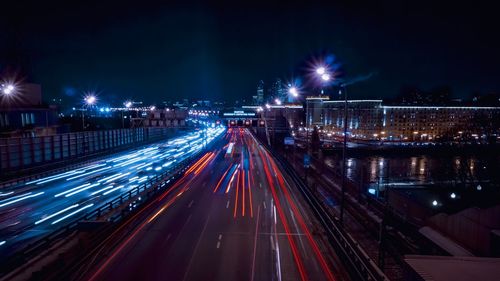 Light trails on road against sky at night