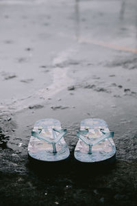 Close-up of shoes on rock by river