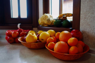 Various fruits in container on table