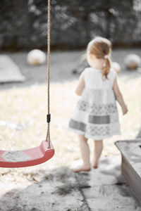 Rear view of girl on swing
