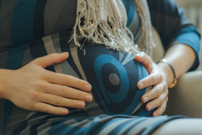 Midsection of woman holding belly