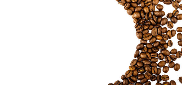 Directly above shot of coffee beans against white background
