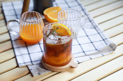 High angle view of orange juice in glass on table