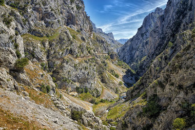 Countryside landscape against rocky mountains