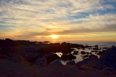 Scenic view of beach against sky during sunset