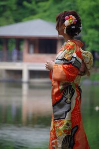 Rear view of couple standing against blurred background