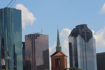 Low angle view of skyscrapers against sky