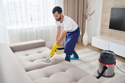 Man working on sofa at home