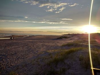 Scenic view of land against sky during sunset