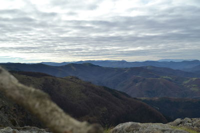 Scenic view of mountains against cloudy sky