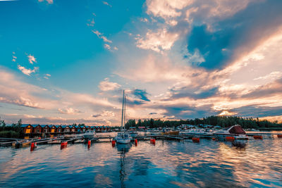 Sailboats in marina at sunset