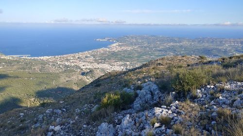 Aerial view of sea and mountains against sky