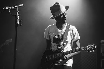 Man playing guitar at music concert