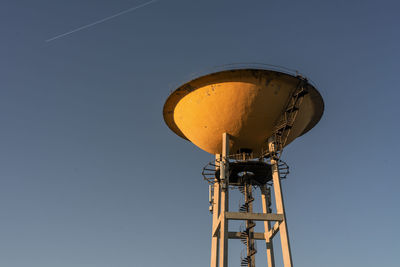 Low angle view of water tower against clear sky