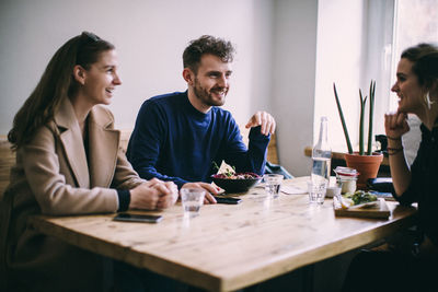 Young couple sitting on table