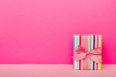 Close-up of gift box against pink background