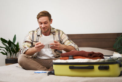 Portrait of senior man sitting on sofa at home