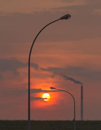 Street lights against sky during sunset