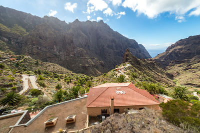 Panoramic view of building and mountains against sky