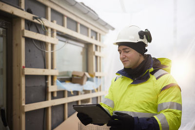 Engineer using digital tablet at building site