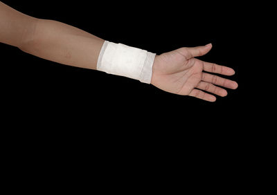 Close-up of hands over black background