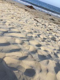 High angle view of footprints on sand at beach