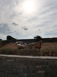 Abandoned building on field against sky