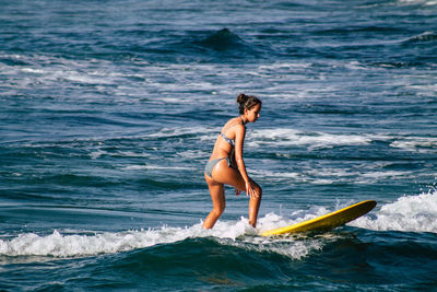 Full length of a man with surfboard in sea