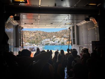 Rear view of people standing in city