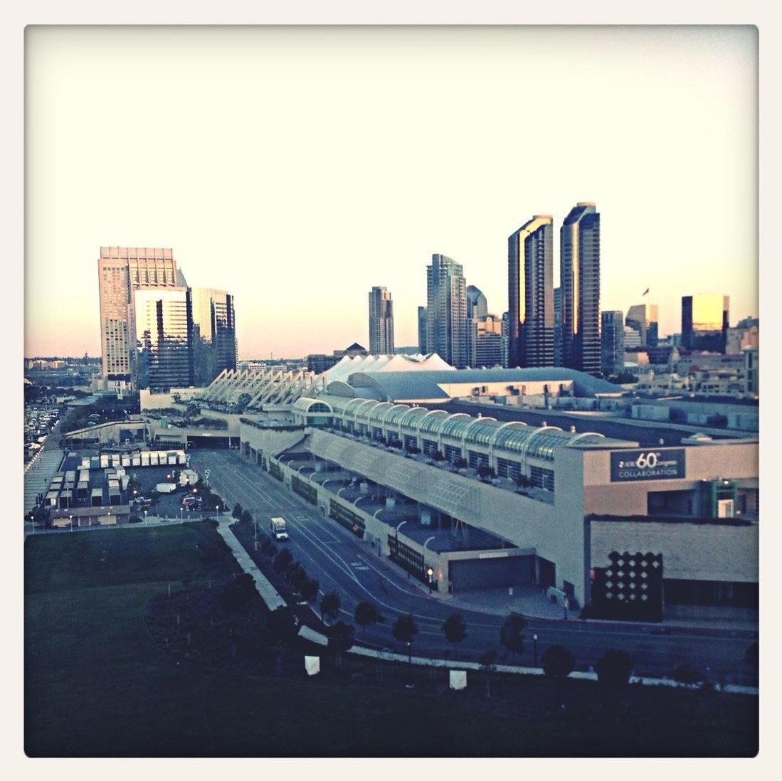 transfer print, building exterior, auto post production filter, architecture, city, built structure, clear sky, copy space, skyscraper, transportation, high angle view, car, cityscape, mode of transport, city life, modern, no people, building, tall - high, tall