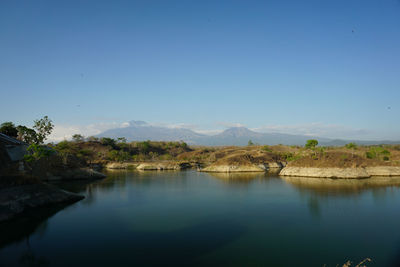 Scenic view of lake against clear blue sky