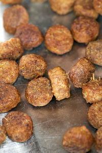 Small meatballs or cat food are freshly prepared in a metal bowl