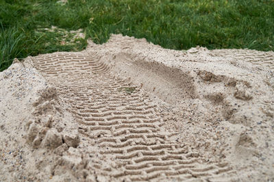 High angle view of tire tracks on dirt road