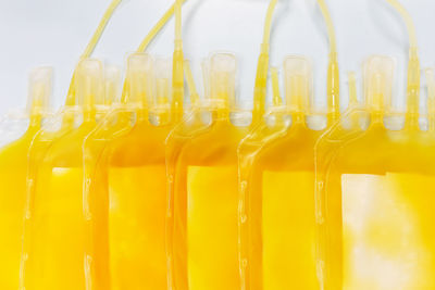 Close-up of yellow bottles in glass container