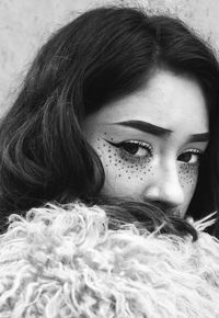 Close-up portrait of young woman with eye make-up