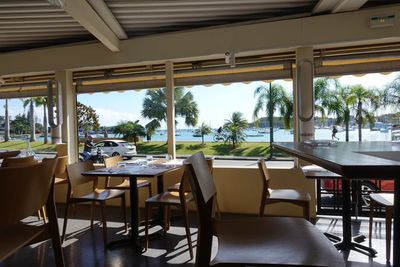 Empty chairs and tables in restaurant