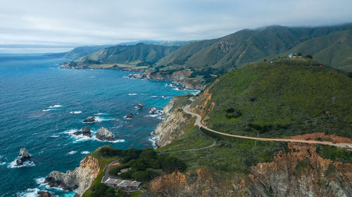 High angle view of sea and mountains against sky