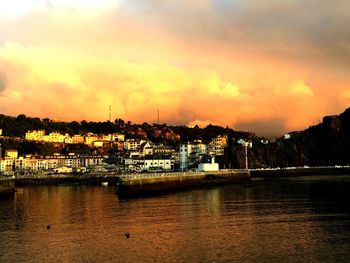 Scenic view of river against sky at sunset