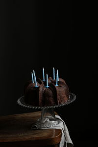 High angle view of illuminated string lights against black background
