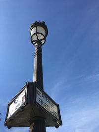 Low angle view of street light against blue sky