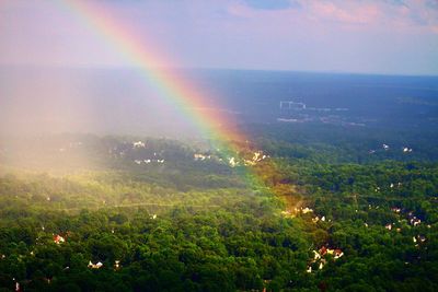 Rainbow over landscape against sky