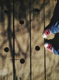 Low section of person on wooden floor